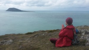 Meditating in sacred landscape near Bardsey Island Wales.